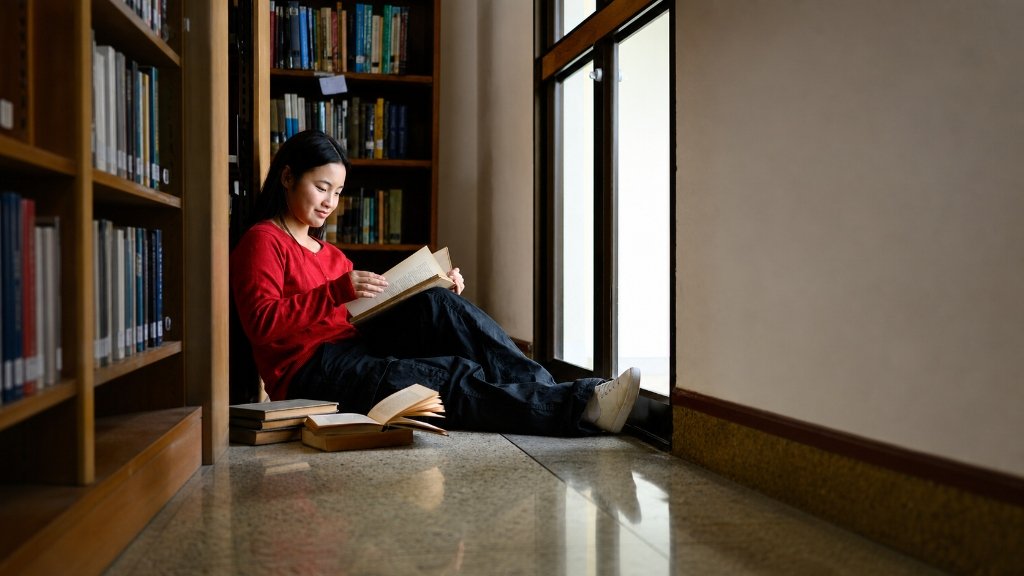 Cannoga College student reading in library